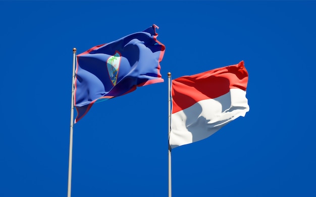 Photo beautiful national state flags of indonesia and guam together on blue sky