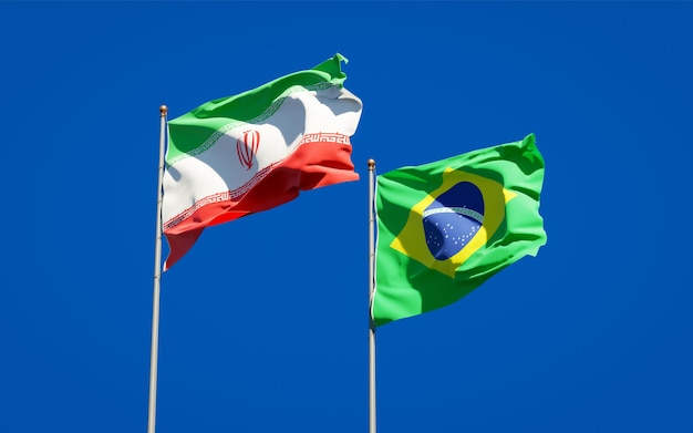 Beautiful national state flags of Iran and Brasil together on blue sky