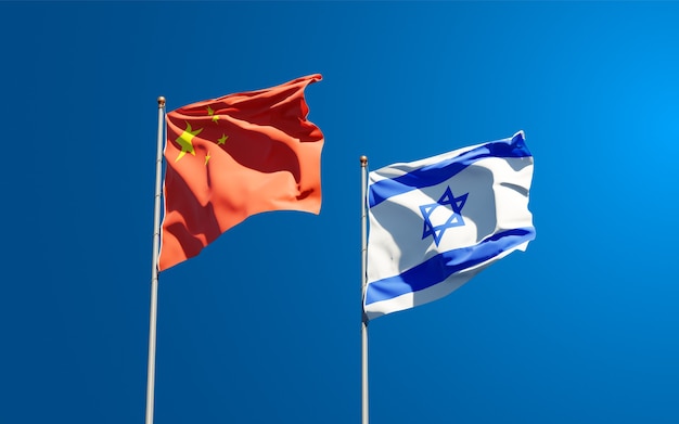 Beautiful national state flags of Israel and China together at the sky background.