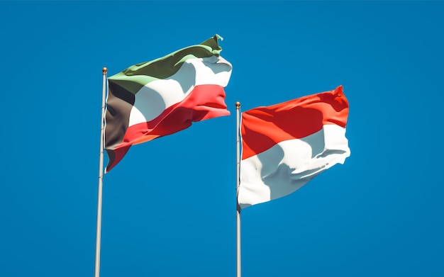 Beautiful national state flags of Kuwait and Indonesia together on blue sky