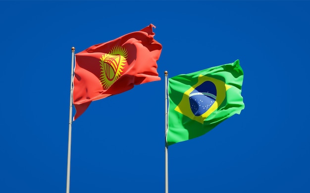 Beautiful national state flags of Kyrgyzstan and Brasil together on blue sky