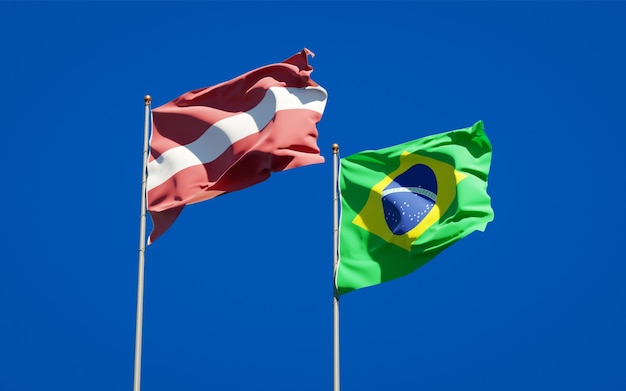 Beautiful national state flags of Latvia and Brasil together on blue sky