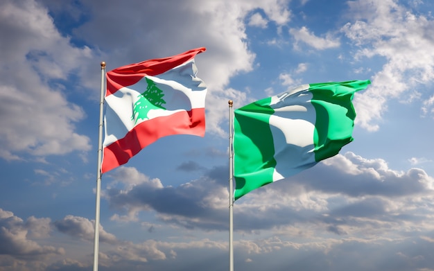 Beautiful national state flags of Lebanon and Nigeria together on blue sky