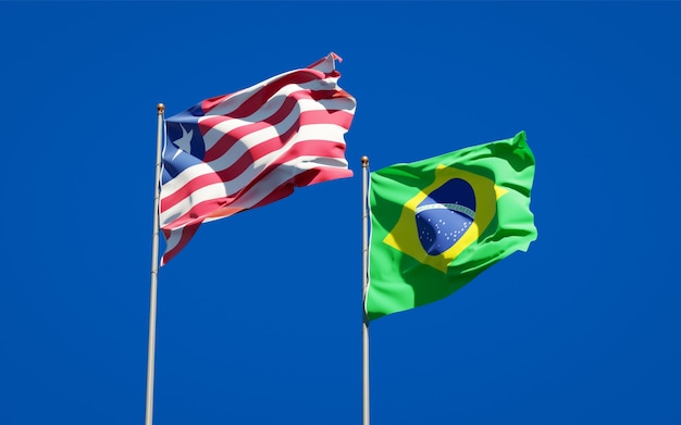 Beautiful national state flags of Liberia and Brasil together on blue sky