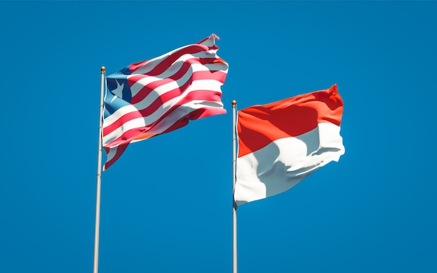 Beautiful national state flags of Liberia and Indonesia together on blue sky