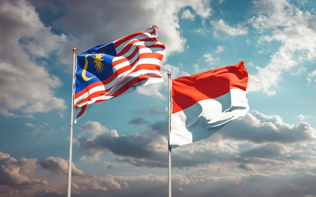 Beautiful national state flags of Malaysia and Indonesia together on blue sky