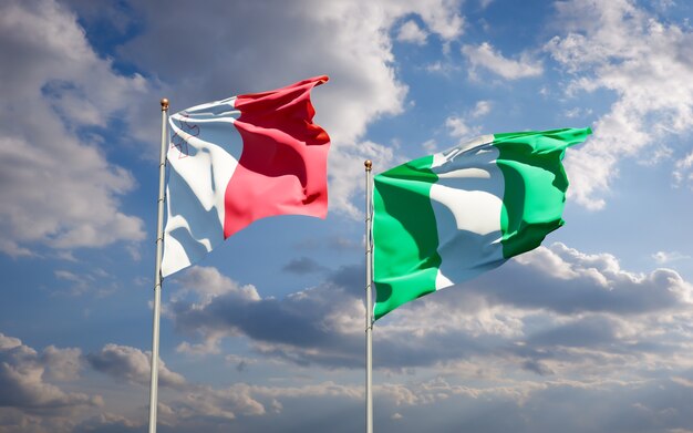 Beautiful national state flags of Malta and Nigeria together on blue sky