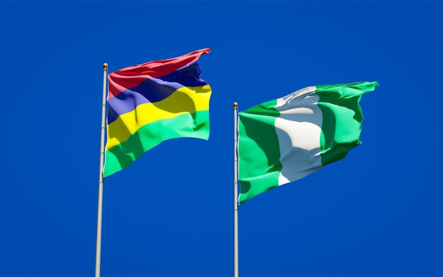 Beautiful national state flags of Mauritius and Nigeria together on blue sky