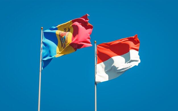 Beautiful national state flags of Moldova and Indonesia together on blue sky