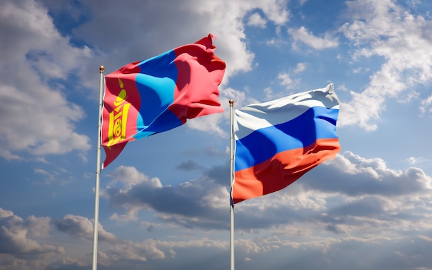 Beautiful national state flags of Mongolia and Russia together on blue sky. 3D artwork