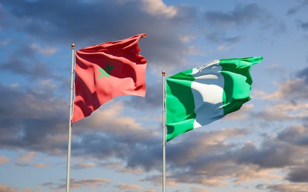 Beautiful national state flags of Morocco and Nigeria together on blue sky