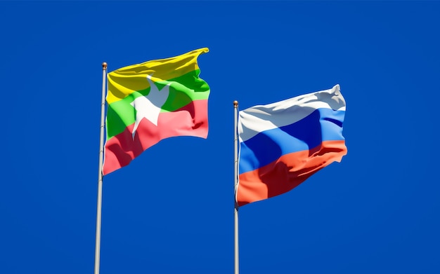 Beautiful national state flags of Myanmar and Russia together on blue sky. 3D artwork