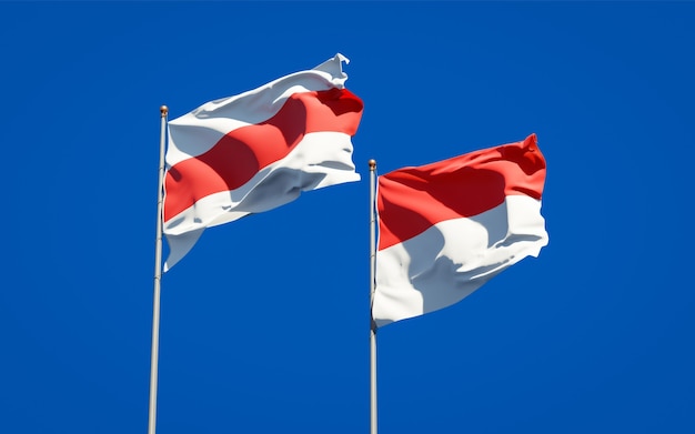 Beautiful national state flags of New Belarus and Indonesia together on blue sky