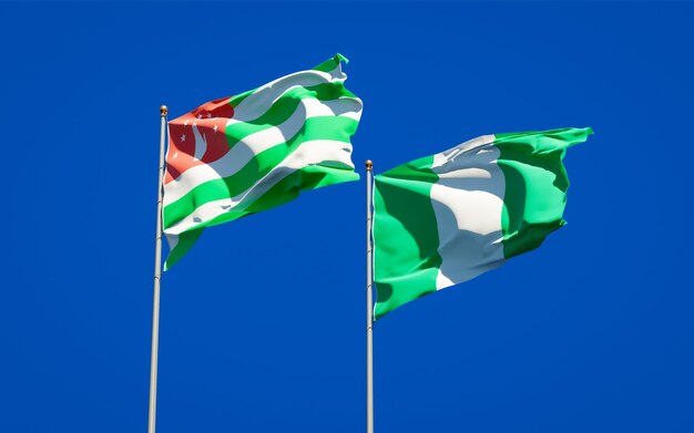 Beautiful national state flags of Nigeria and Abkhazia together on blue sky