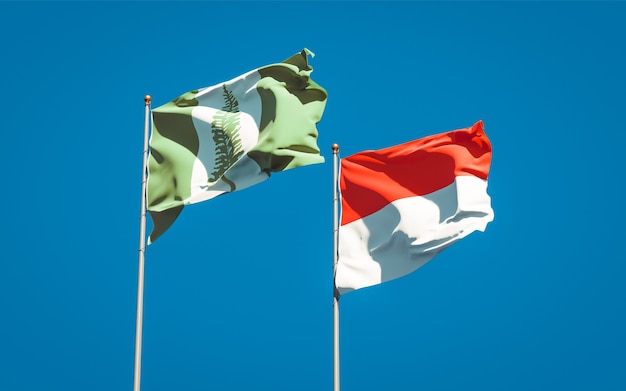 Beautiful national state flags of Norfolk Island and Indonesia together on blue sky