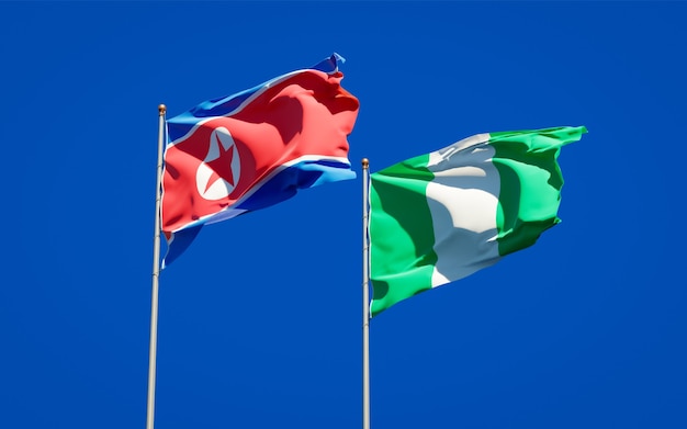 Beautiful national state flags of North Korea and Nigeria together on blue sky