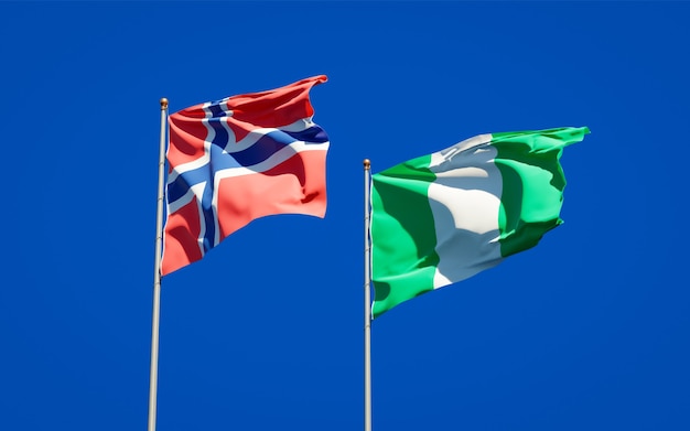 Beautiful national state flags of Norway and Nigeria together on blue sky