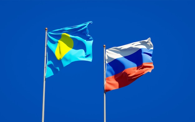 Beautiful national state flags of Palau and Russia together on blue sky. 3D artwork