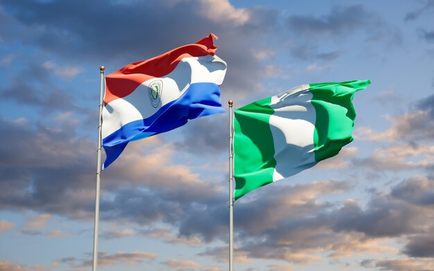 Beautiful national state flags of Paraguay and Nigeria together on blue sky