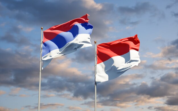 Beautiful national state flags of Republika Srpska and Indonesia together on blue sky