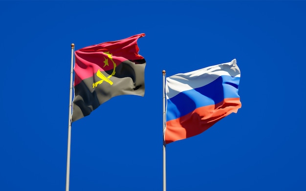 Beautiful national state flags of Russia and Angola together on blue sky. 3D artwork