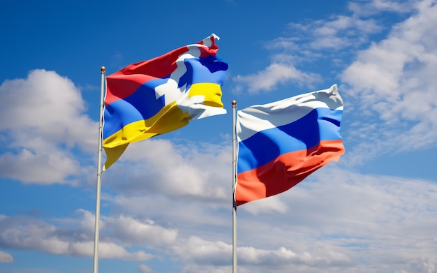 Beautiful national state flags of Russia and Artsakh together on blue sky. 3D artwork