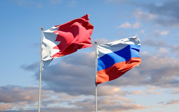 Beautiful national state flags of Russia and Bahrain together on blue sky. 3D artwork