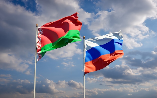 Beautiful national state flags of Russia and Belarus together on blue sky. 3D artwork