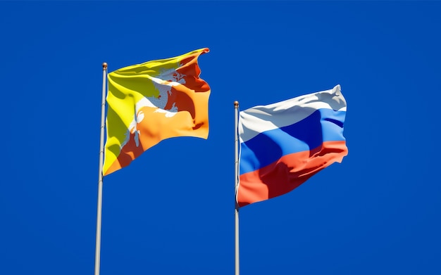 Beautiful national state flags of Russia and Bhutan together on blue sky. 3D artwork