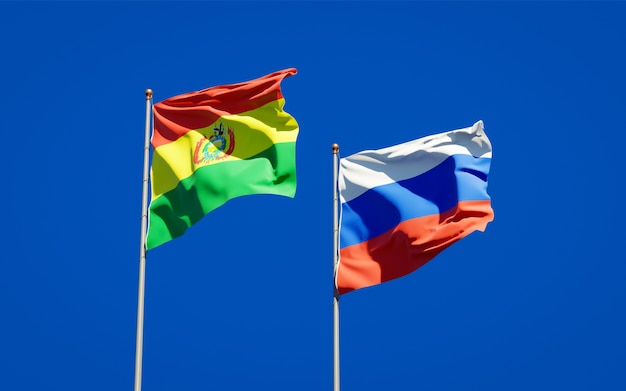 Beautiful national state flags of Russia and Bolivia together on blue sky. 3D artwork