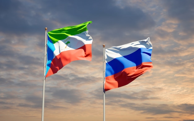 Beautiful national state flags of Russia and Equatorial Guinea together on blue sky. 3D artwork