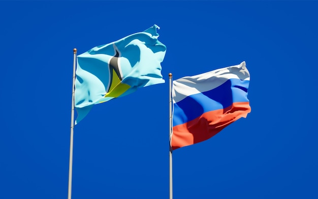 Beautiful national state flags of Saint Lucia and Russia together on blue sky. 3D artwork