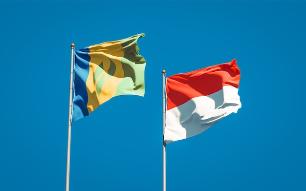 Beautiful national state flags of Saint Vincent and the Grenadines and Indonesia together on blue sky