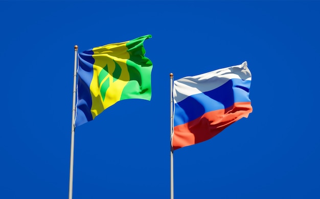 Beautiful national state flags of Saint Vincent and the Grenadines and Russia together on blue sky. 3D artwork