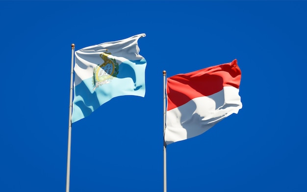 Beautiful national state flags of San Marino and Indonesia together on blue sky