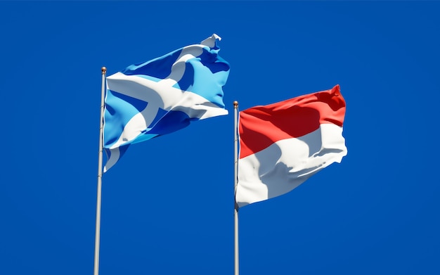 Beautiful national state flags of Scotland and Indonesia together on blue sky