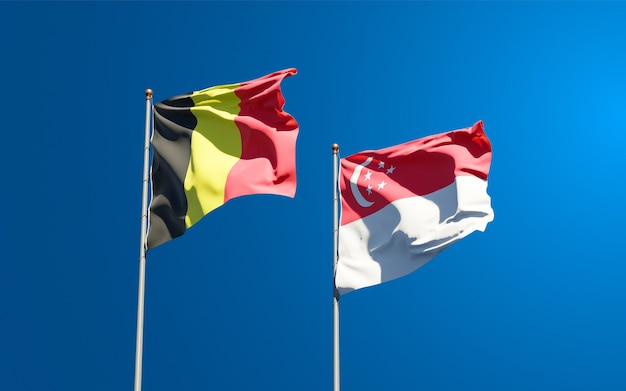 Photo beautiful national state flags of singapore and belgium