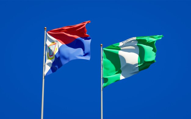 Beautiful national state flags of Sint Maarten and Nigeria together on blue sky