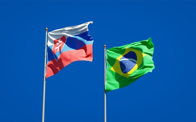 Beautiful national state flags of Slovakia and Brasil together on blue sky