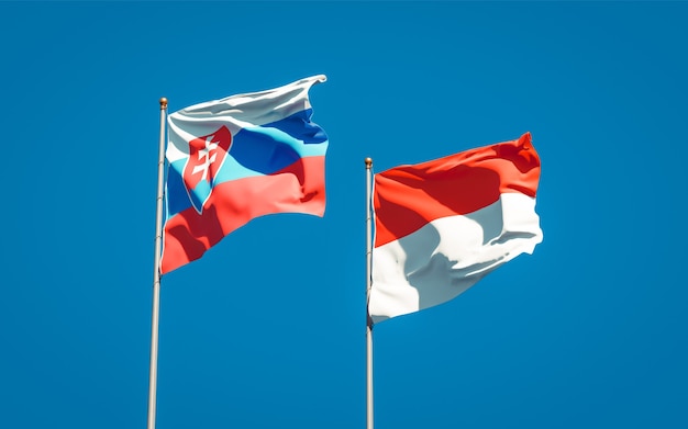 Beautiful national state flags of Slovakia and Indonesia together on blue sky