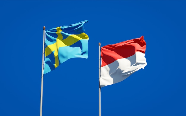 Beautiful national state flags of Sweden and Indonesia together on blue sky