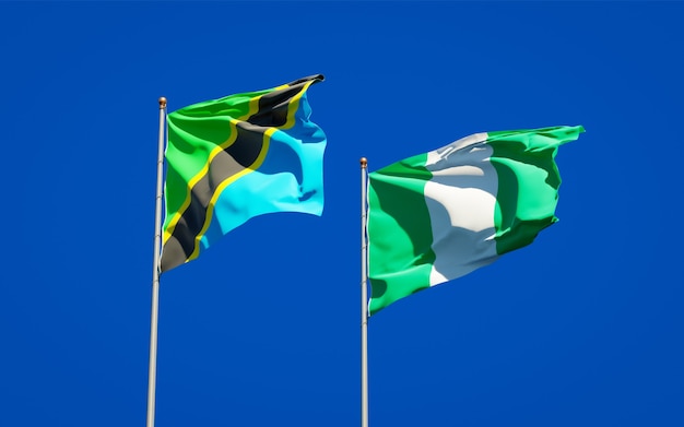 Beautiful national state flags of Tanzania and Nigeria together on blue sky