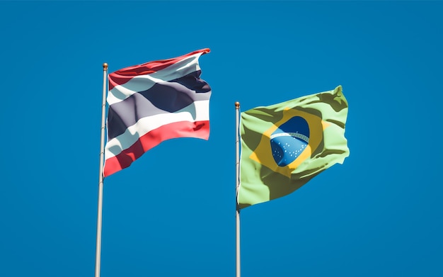 Beautiful national state flags of Thailand and Brasil together on blue sky