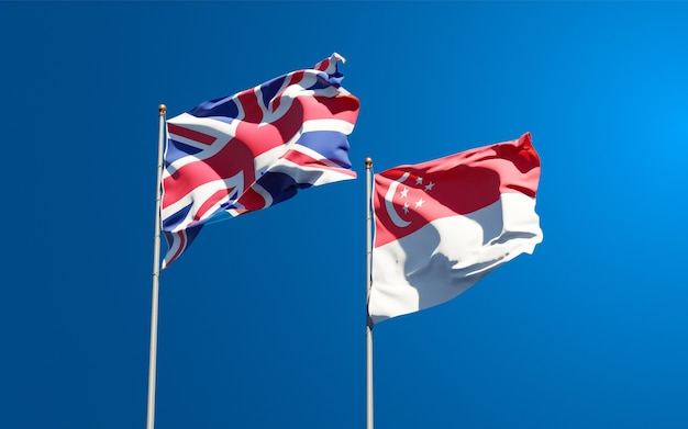 Photo beautiful national state flags of uk and singapore together