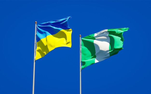 Beautiful national state flags of Ukraine and Nigeria together on blue sky