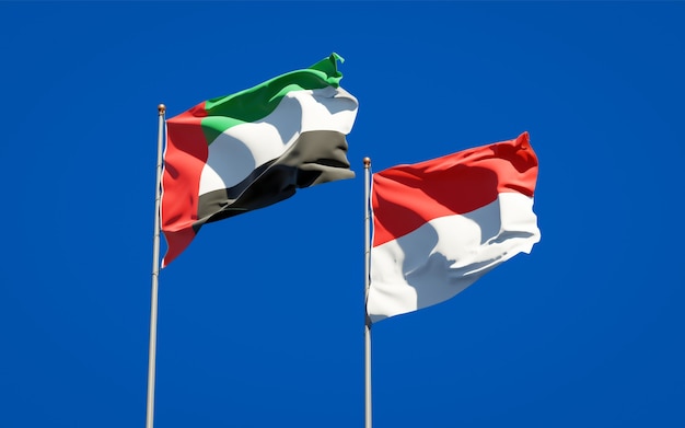 Beautiful national state flags of United Arab Emirates UAE and Indonesia together on blue sky