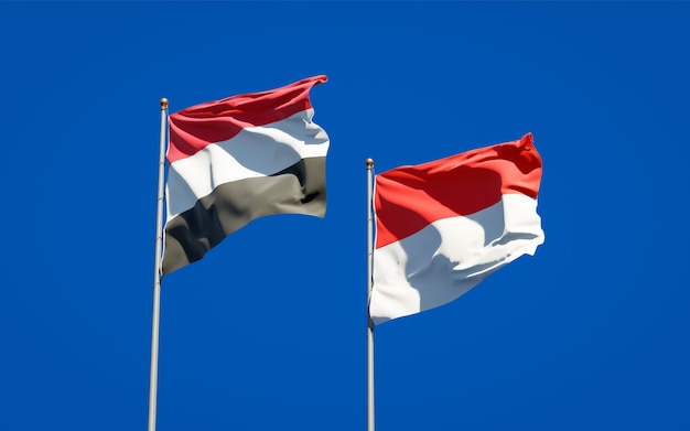 Beautiful national state flags of Yemen and Indonesia together on blue sky