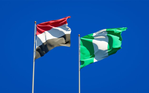 Beautiful national state flags of Yemen and Nigeria together on blue sky