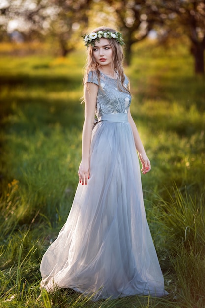 Beautiful natural woman in the blooming garden