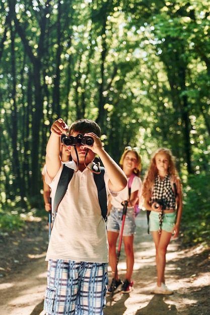 Beautiful nature Kids strolling in the forest with travel equipment